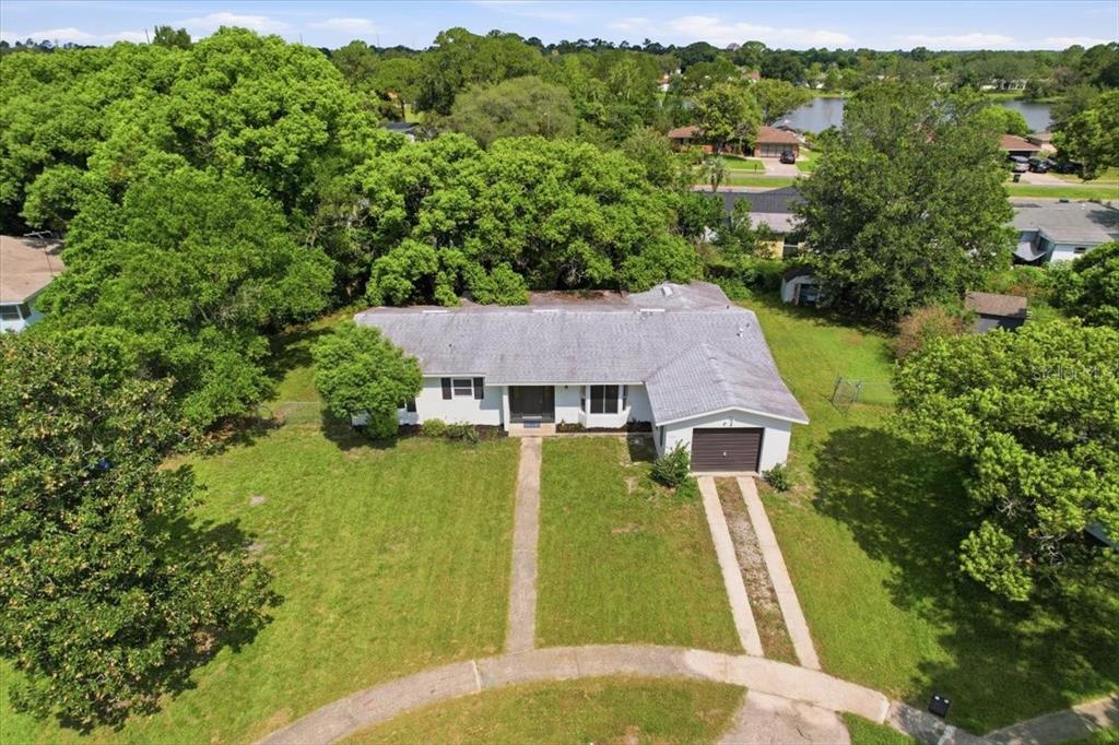 An aerial view of a single-story house with a gray roof, garage, and front walkway — 1220 SIENNA COURT, DELTONA, FL