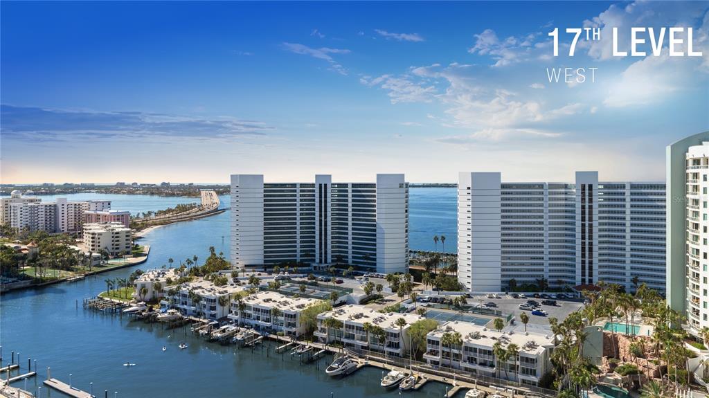 An aerial view shows high-rise apartment buildings, a marina, and a bridge over the water — 1000 BOULEVARD OF THE ARTS UNIT 1710, SARASOTA, FL