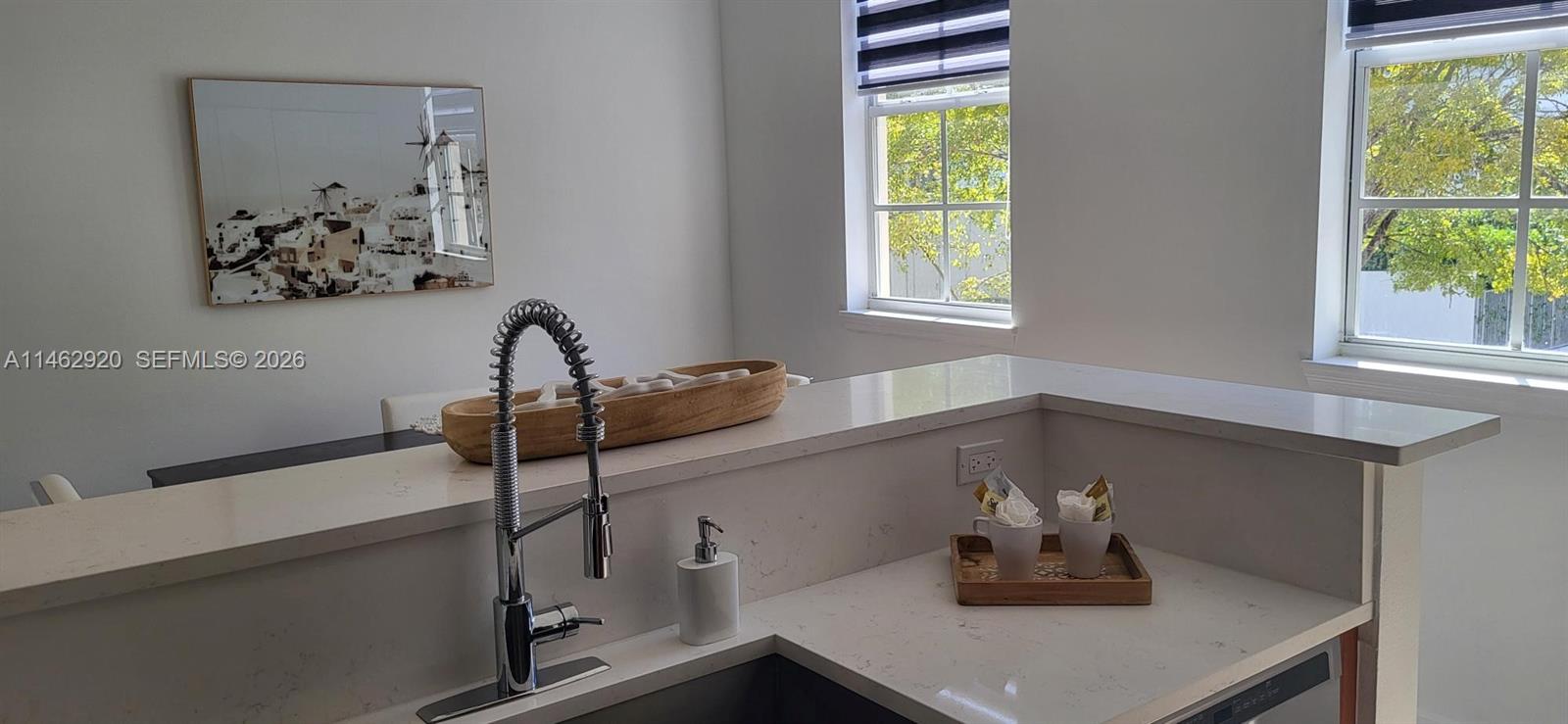 A kitchen sink area features white quartz countertops, a chrome faucet, and two windows — 2069 S Ocean Dr, Hallandale Beach FL 33009, HALLANDALE BEACH, FL