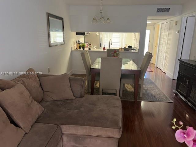 A living room with a sectional sofa leads to a dining area and open kitchen — 1207 Bahama Bnd # E2, Coconut Creek FL 33066, COCONUT CREEK, FL