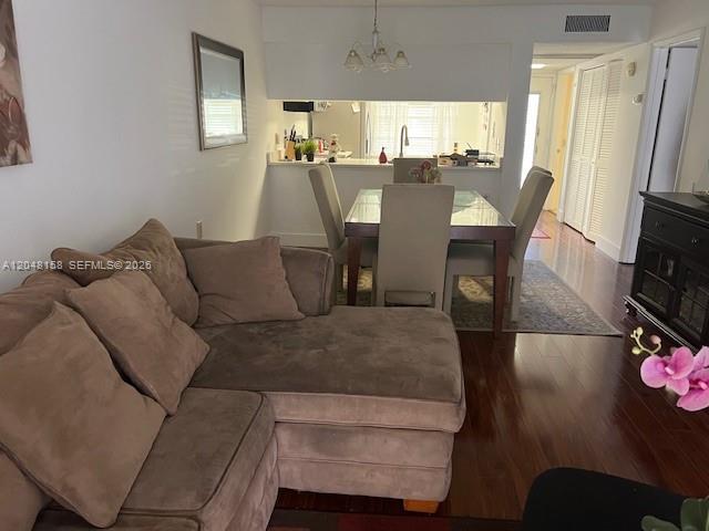 A living room with a brown sectional sofa faces a dining area with a glass table — 1207 Bahama Bnd # E2, Coconut Creek FL 33066, COCONUT CREEK, FL