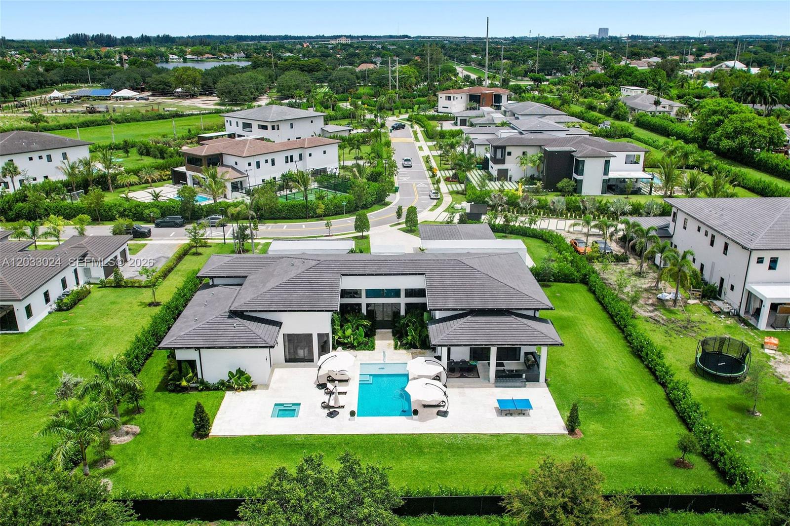 An aerial view shows a modern house with a pool, patio, and large grassy yard — 14910 SW 16th Ct, Davie FL 33326, DAVIE, FL