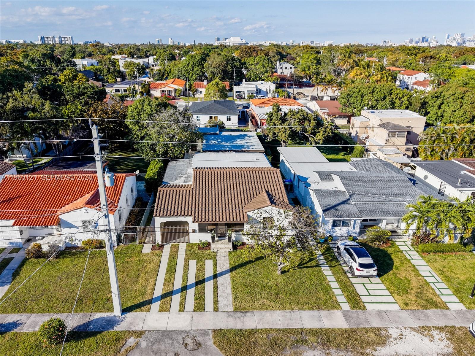 An aerial view shows a residential street with several houses, including one with a tiled roof — 1631 SW 21st St, Miami FL 33145, MIAMI, FL