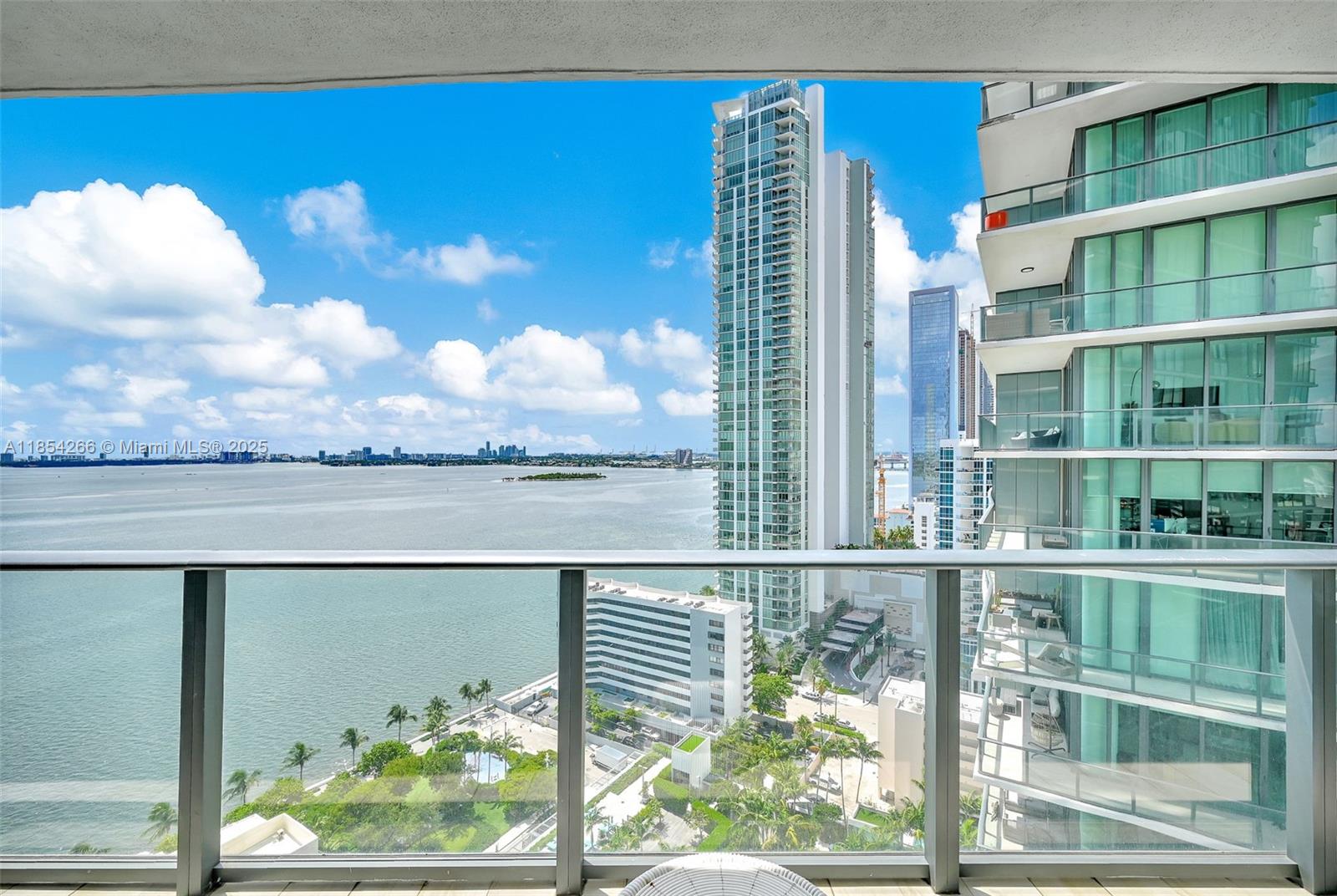 A balcony view overlooks a large body of water, nearby high-rise buildings, and a park — 650 NE 32nd St # 2201, Miami FL 33137, MIAMI, FL