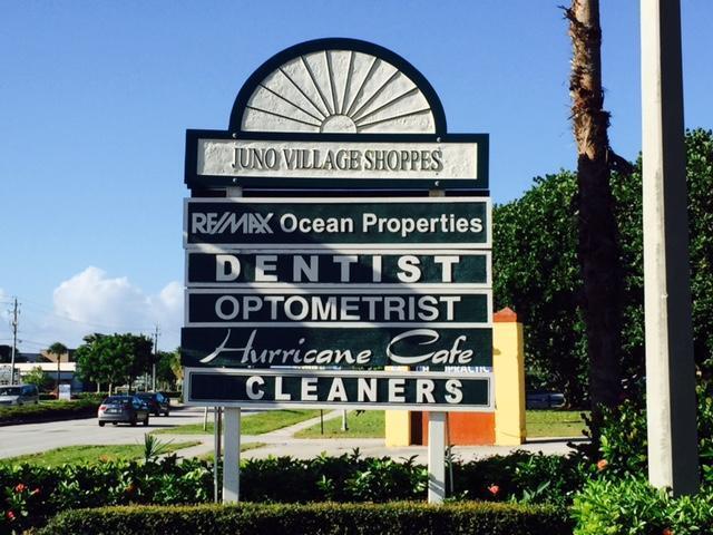 A sign for Juno Village Shoppes lists several businesses including a dentist and a cafe — 14050 Us Highway 1 # F, Juno Beach FL 33408, JUNO BEACH, FL