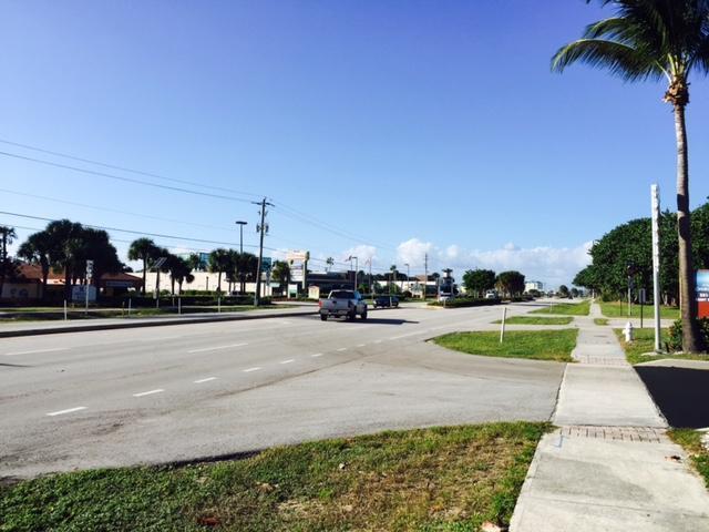 A view of a multi-lane road with a pickup truck driving past commercial buildings — 14050 Us Highway 1 # F, Juno Beach FL 33408, JUNO BEACH, FL