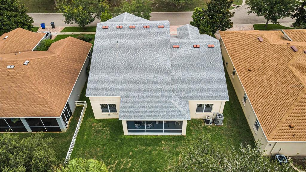 An aerial view shows the gray shingled roof of a house between two tan-roofed homes — 11217 LAUREL BROOK COURT, RIVERVIEW, FL