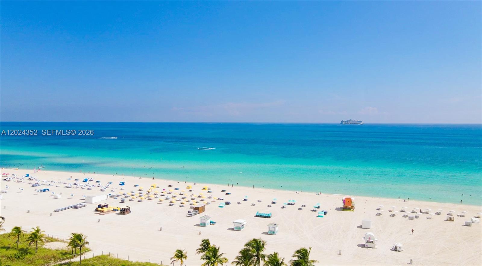An aerial view of a sandy beach with palm trees and a cruise ship offshore — 934 Meridian Ave # 7, Miami Beach FL 33139, MIAMI BEACH, FL
