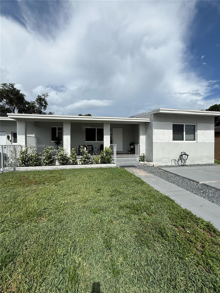 A single-story house with a covered front porch, white brick accents, and a grassy lawn — 6825 NW 5th Ct # 0, Miami FL 33150, MIAMI, FL