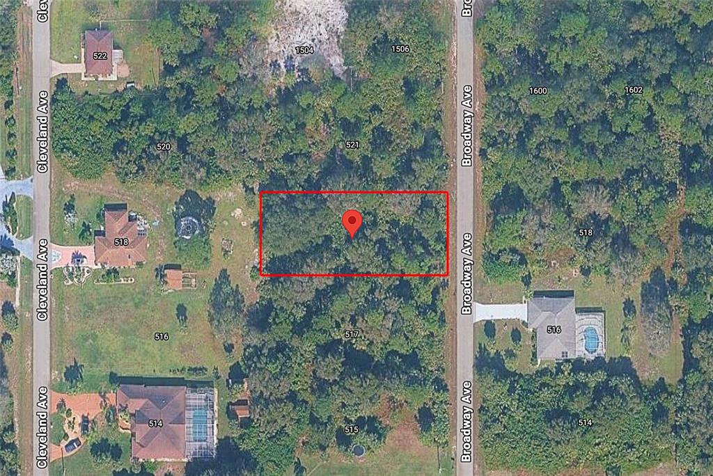 This is an aerial map showing a vacant, wooded lot highlighted by a red rectangle — 519 BROADWAY AVENUE, LEHIGH ACRES, FL