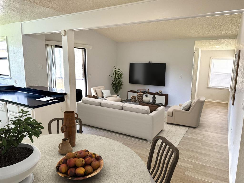 An empty room features light wood-look flooring, a textured ceiling, and a sliding glass door — 3019 ANTIQUE OAKS CIRCLE UNIT 124, WINTER PARK, FL