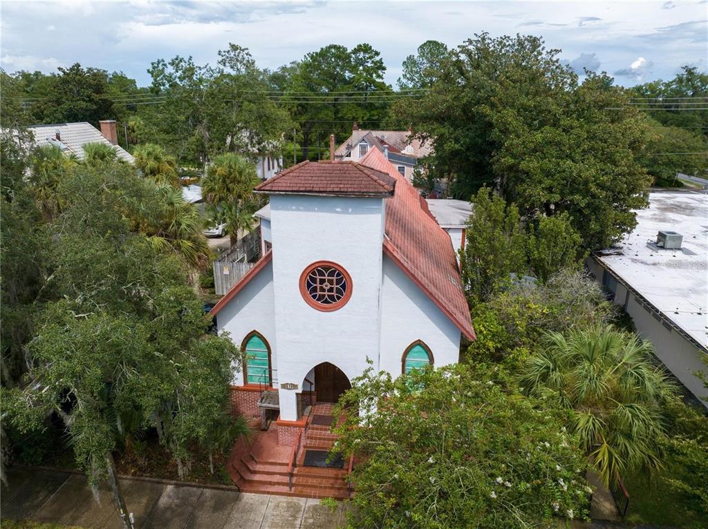An aerial view of a white church building with a red roof and arched windows — 619 NE 1ST STREET, GAINESVILLE, FL