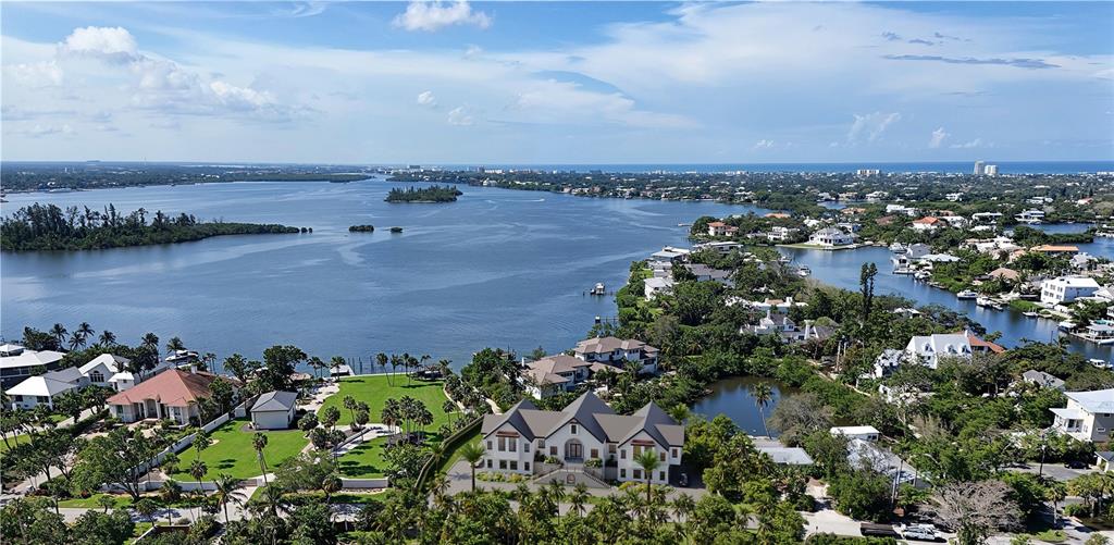 An aerial view shows luxury waterfront homes along a bay with lush tropical landscaping — 546 FREELING DRIVE, SARASOTA, FL