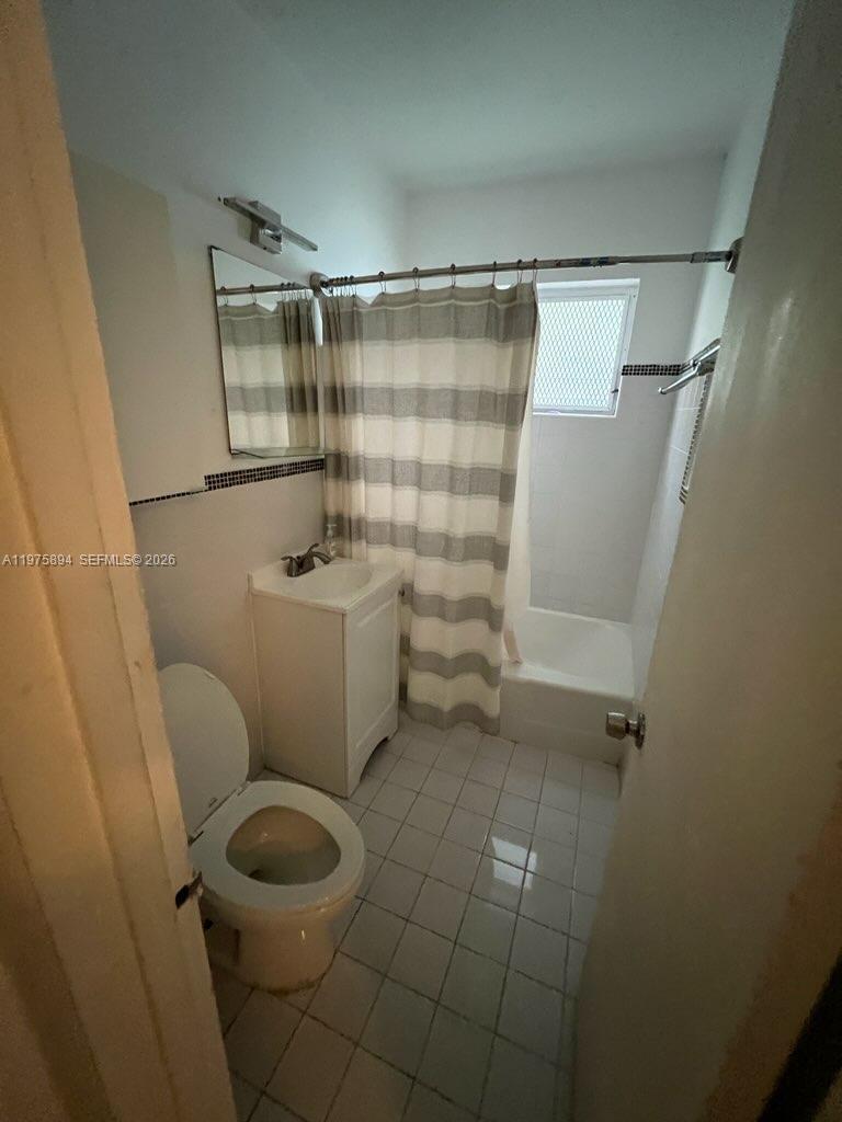 A small bathroom features a white vanity, a toilet, and a shower-tub combination — 761 Euclid Ave # 12B, Miami Beach FL 33139, MIAMI BEACH, FL