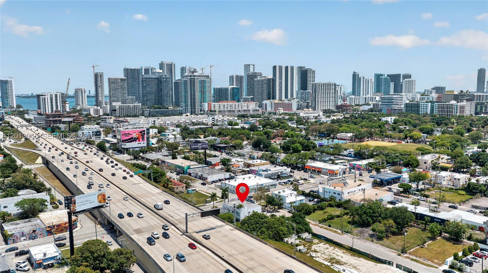 An aerial view shows a small building marked with a red pin near a highway — 201 NW 37th St, Miami FL 33127, MIAMI, FL