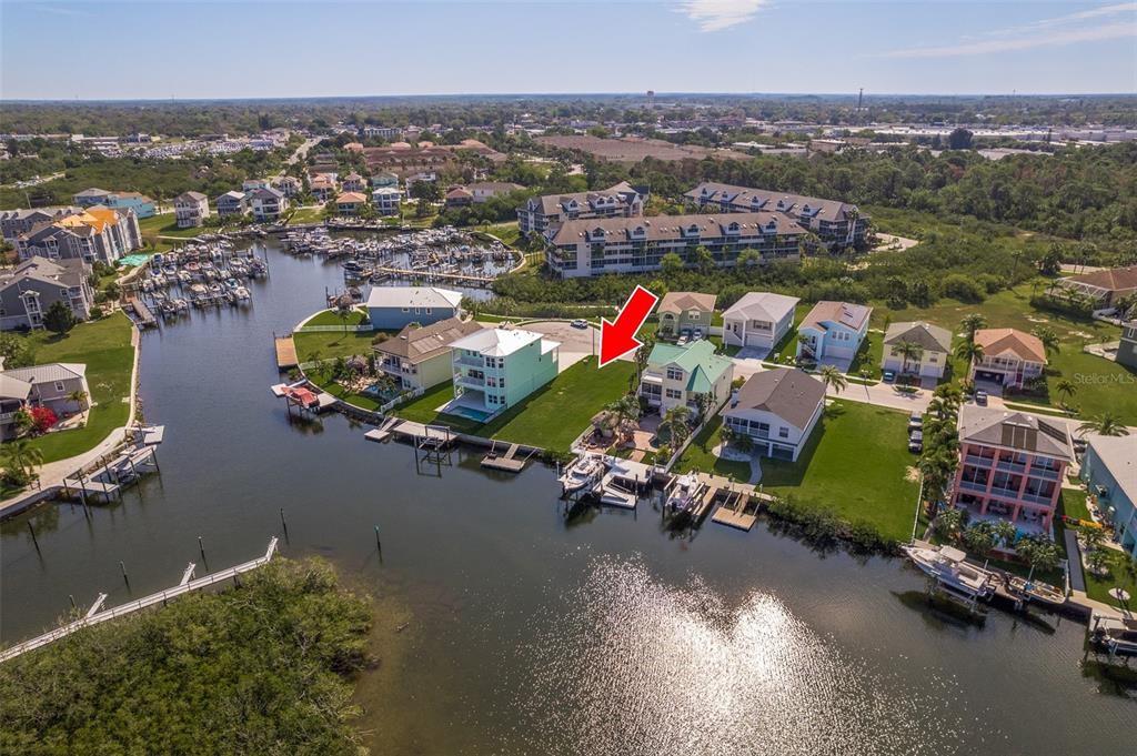 An aerial view shows waterfront houses with private docks along a canal in a neighborhood — 5627 JOBETH DRIVE, NEW PORT RICHEY, FL