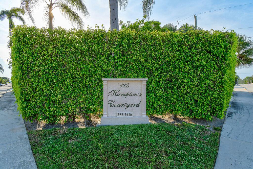 A stone sign for Hampton's Courtyard stands in front of a tall, dense green hedge — 172 N County Road, Palm Beach FL 33480, PALM BEACH, FL