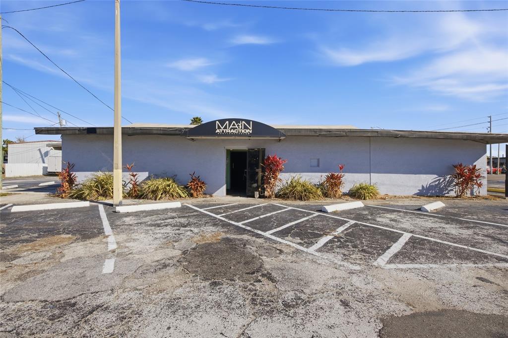 The exterior of a single-story commercial building with a parking lot in the foreground — 4900 66TH STREET N, ST PETERSBURG, FL