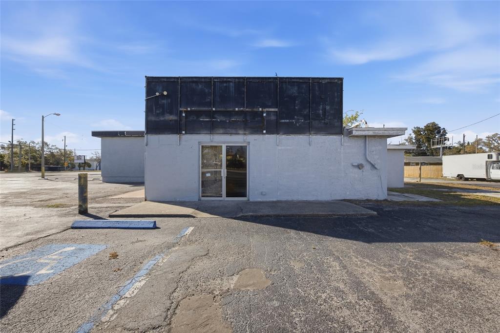 A single-story commercial building with a gray facade and a large black sign frame — 4900 66TH STREET N, ST PETERSBURG, FL