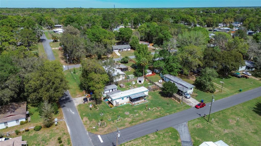 An aerial view shows a residential lot with a single-story house and a detached structure — 7951 E PARTRIDGE LANE, FLORAL CITY, FL