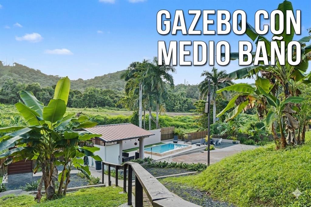 An outdoor swimming pool and a gazebo with a bathroom are set in a landscape — Cofresi MAMEYES UNIT 57, LUQUILLO, PR