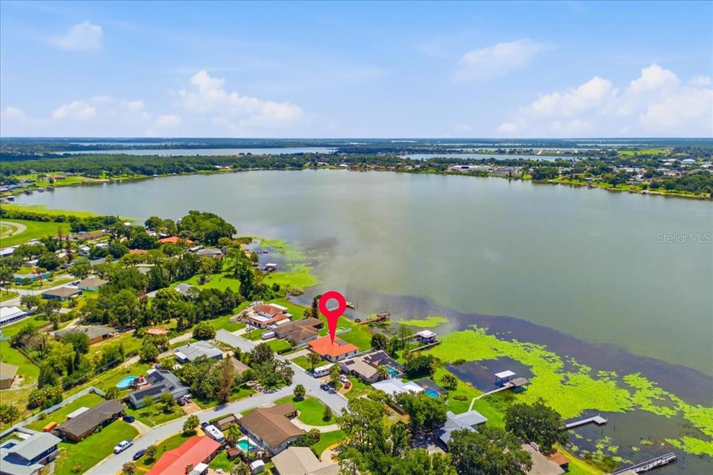 An aerial view of a waterfront house with a red location pin — 2004 LEISURE DRIVE, WINTER HAVEN, FL