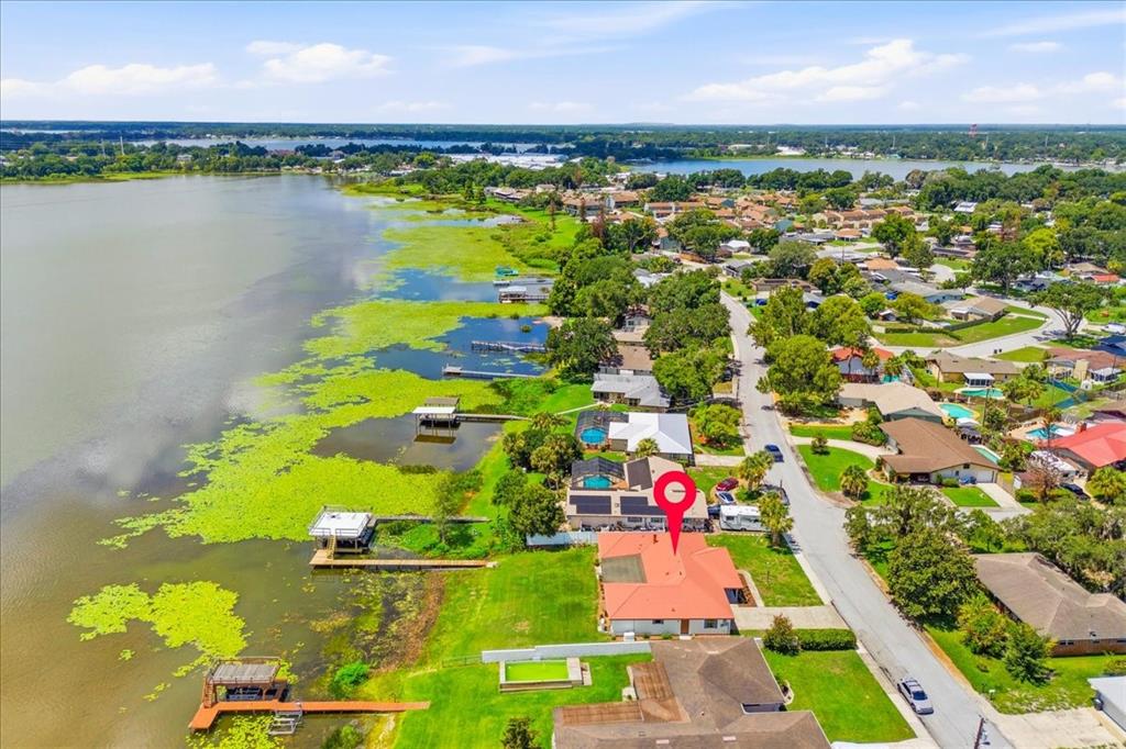 An aerial view of a waterfront house with a red roof and private boat dock — 2004 LEISURE DRIVE, WINTER HAVEN, FL