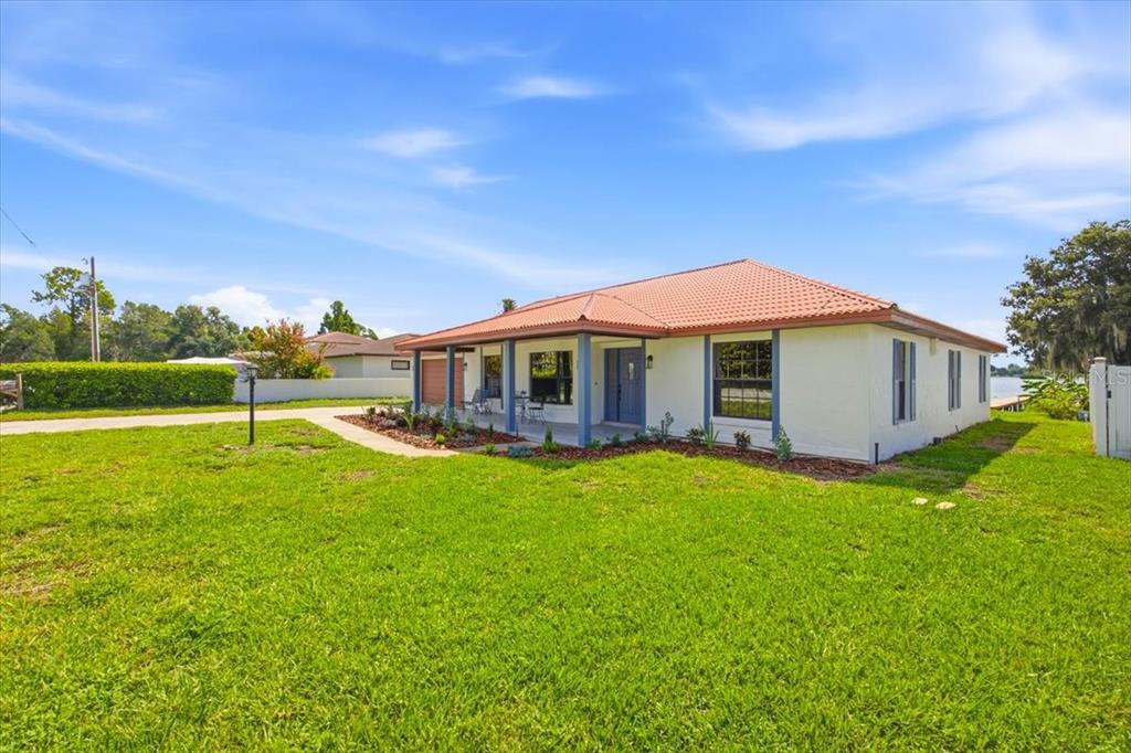 A single-story house with a red tile roof and a covered front porch — 2004 LEISURE DRIVE, WINTER HAVEN, FL