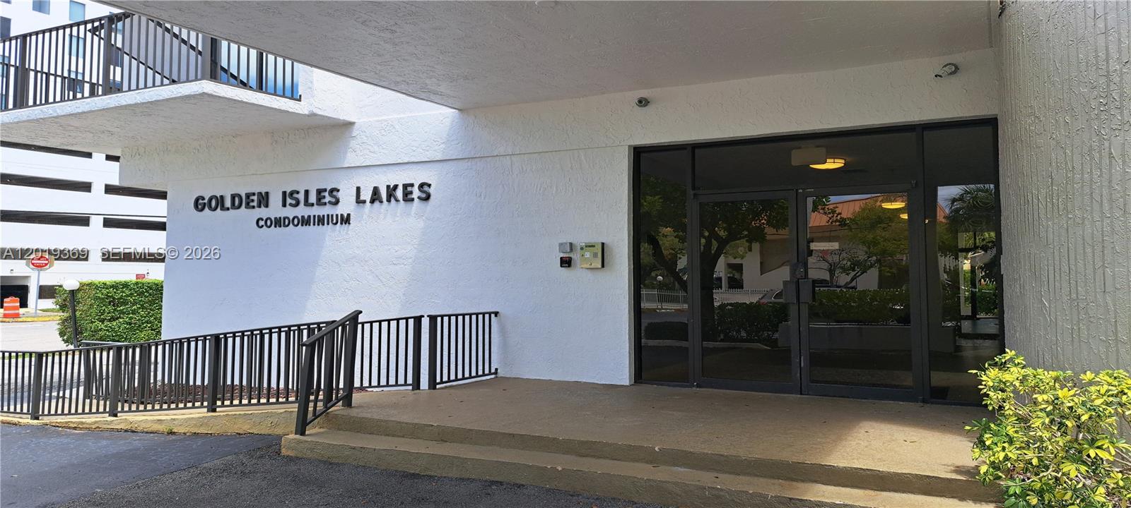 The exterior entrance of the Golden Isles Lakes Condominium features a white facade and stairs — 1900 Diana Dr # 3E, Hallandale Beach FL 33009, HALLANDALE BEACH, FL