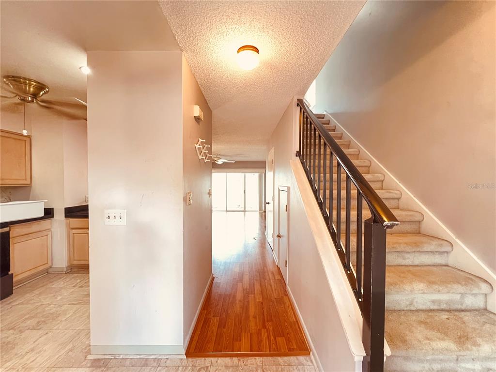 The exterior of a pink two-story house features a white front door and walkway — 4931 WALDEN CIRCLE UNIT 55, ORLANDO, FL
