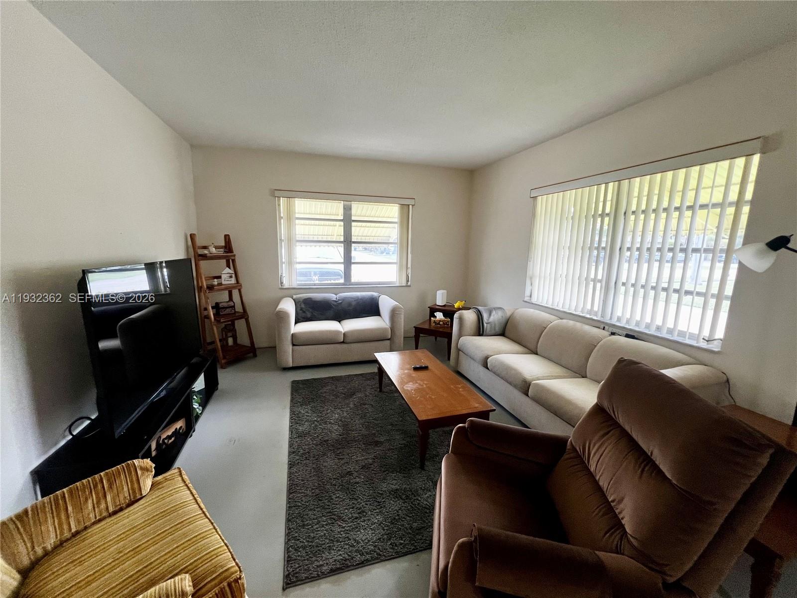 A living room features a television, a sofa, a loveseat, and a recliner — 1501 Arthur St # 5, Hollywood FL 33020, HOLLYWOOD, FL