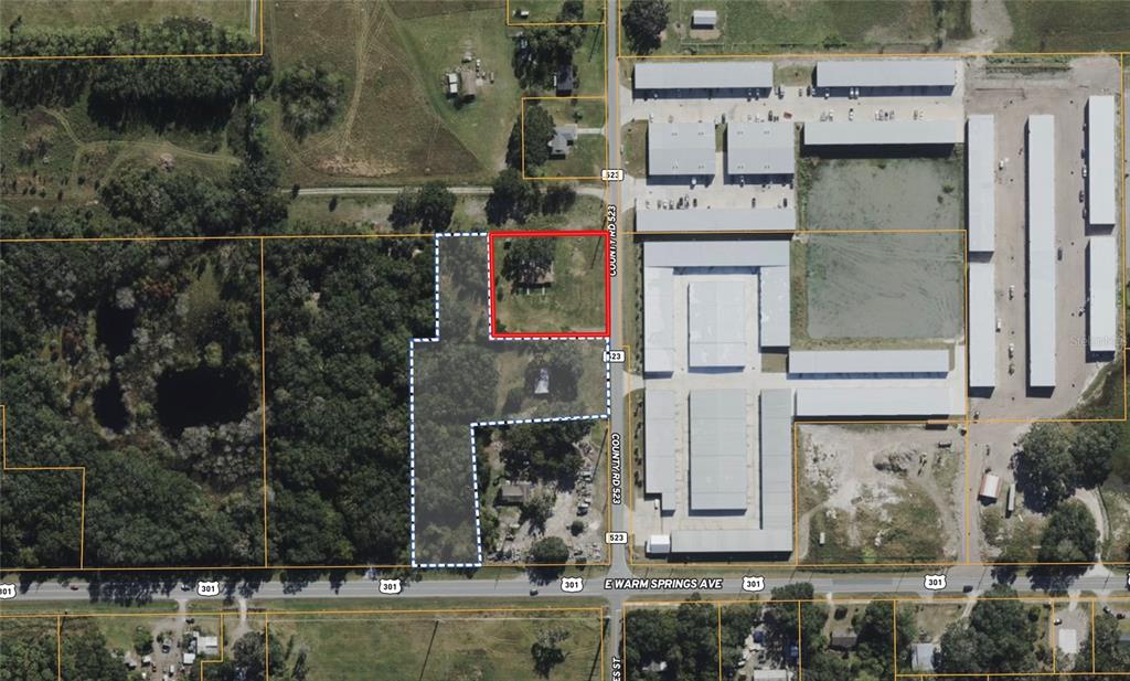 This aerial map shows a property parcel outlined in red and blue near a road — 2889 COUNTY ROAD 523, WILDWOOD, FL