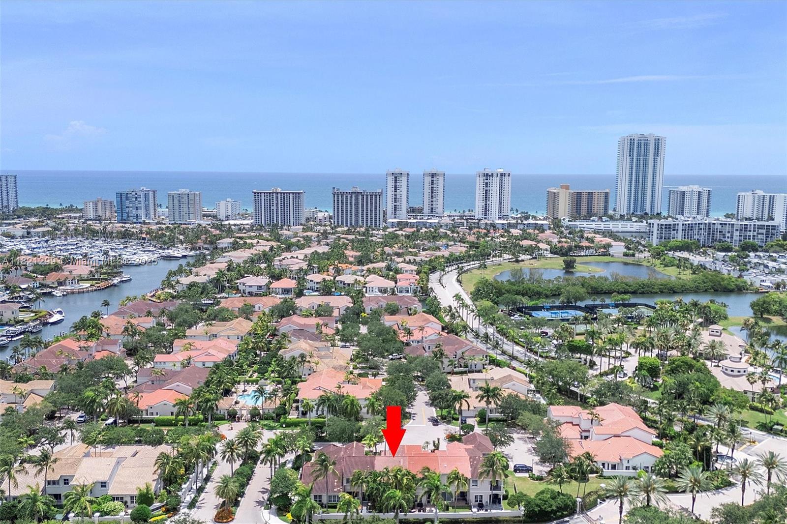An aerial view shows a residential neighborhood with a red arrow pointing to a townhouse — 1382 Harbor Vw W, Hollywood FL 33019, HOLLYWOOD, FL