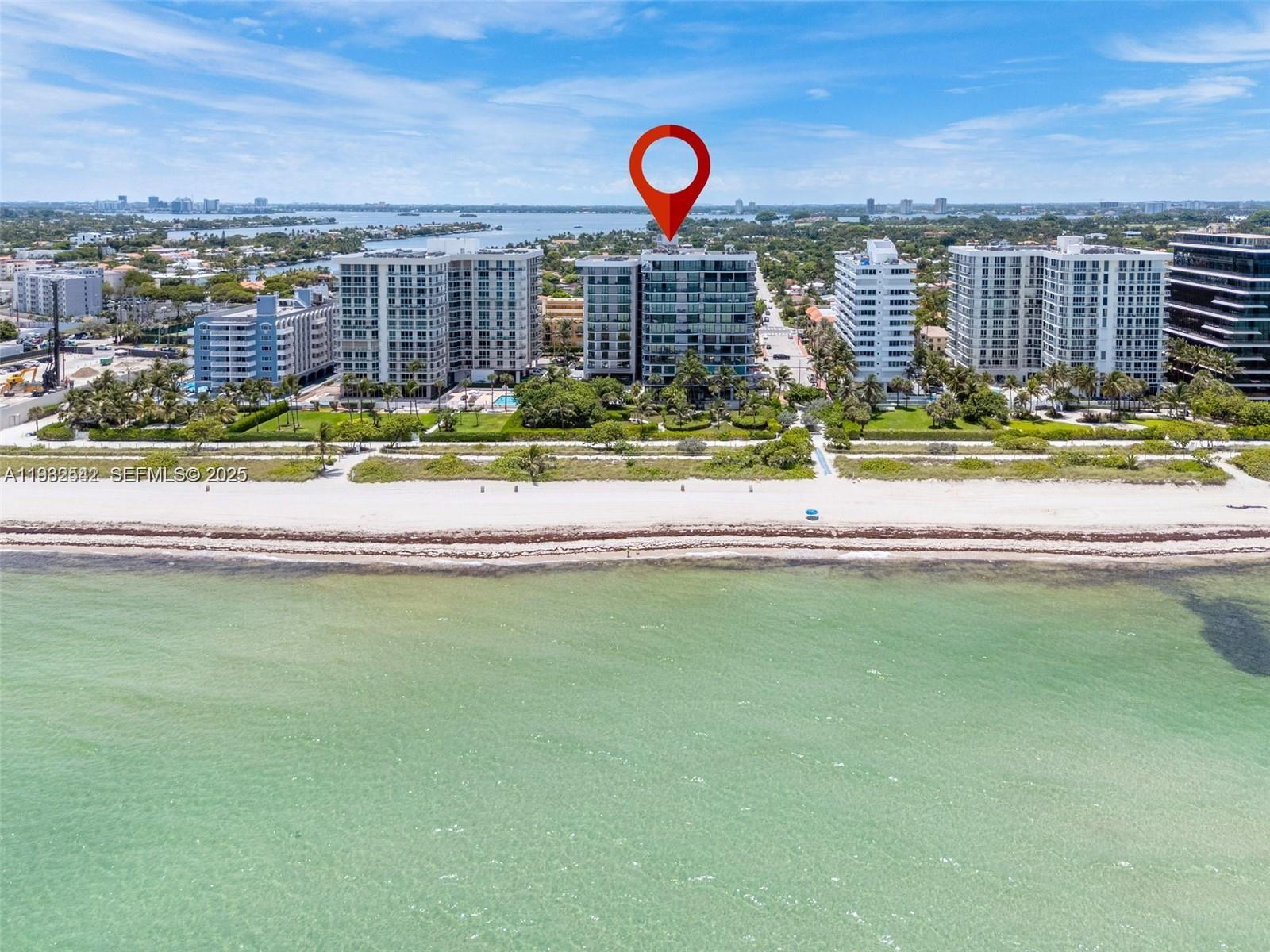 An aerial view shows a beachfront condominium building marked with a red location pin — 8877 Collins Ave # 805, Surfside FL 33154, SURFSIDE, FL