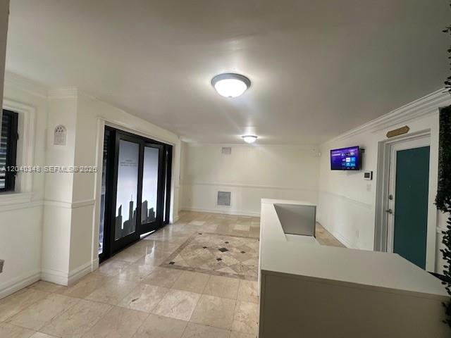 A bright lobby features tile flooring, a reception desk, and a wall-mounted television — 4237 NW 37 Ave # 4237, Miami FL 33142, MIAMI, FL