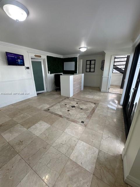 A reception area features a white desk, tile flooring, and a wall-mounted television — 4237 NW 37 Ave # 4237, Miami FL 33142, MIAMI, FL