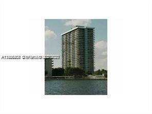 A tall residential high-rise building stands along the edge of a body of water — 780 NE 69th St # 1406, Miami FL 33138, MIAMI, FL