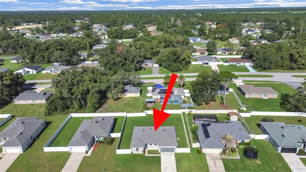 An aerial view shows a single-story house with a gray roof and a fenced backyard — 15094 SW 43RD AVENUE ROAD, OCALA, FL