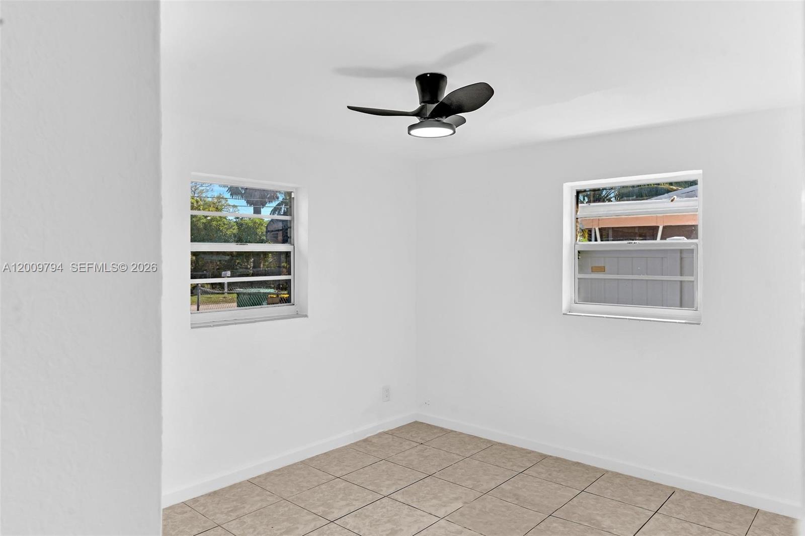 An empty room features white walls, tiled flooring, and a ceiling fan with a light — 4156 SW 49th Ct # 0, Dania Beach FL 33314, DANIA BEACH, FL