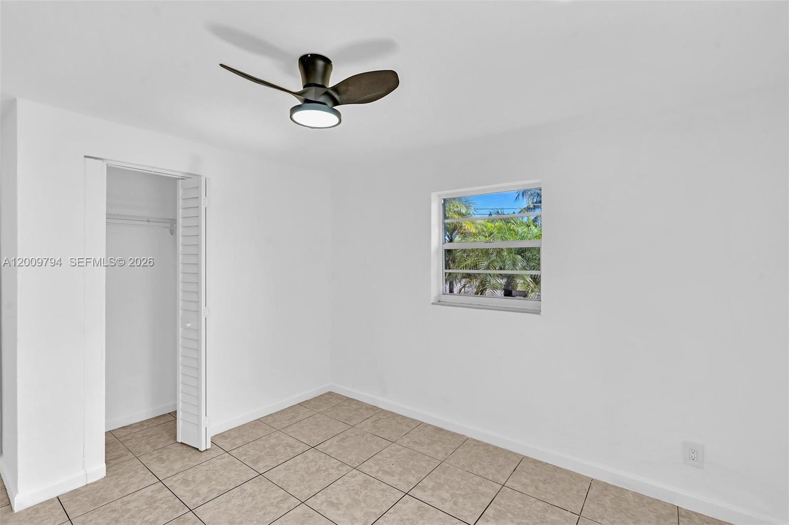 An empty bedroom features white walls, tiled flooring, a ceiling fan, and a closet — 4156 SW 49th Ct # 0, Dania Beach FL 33314, DANIA BEACH, FL