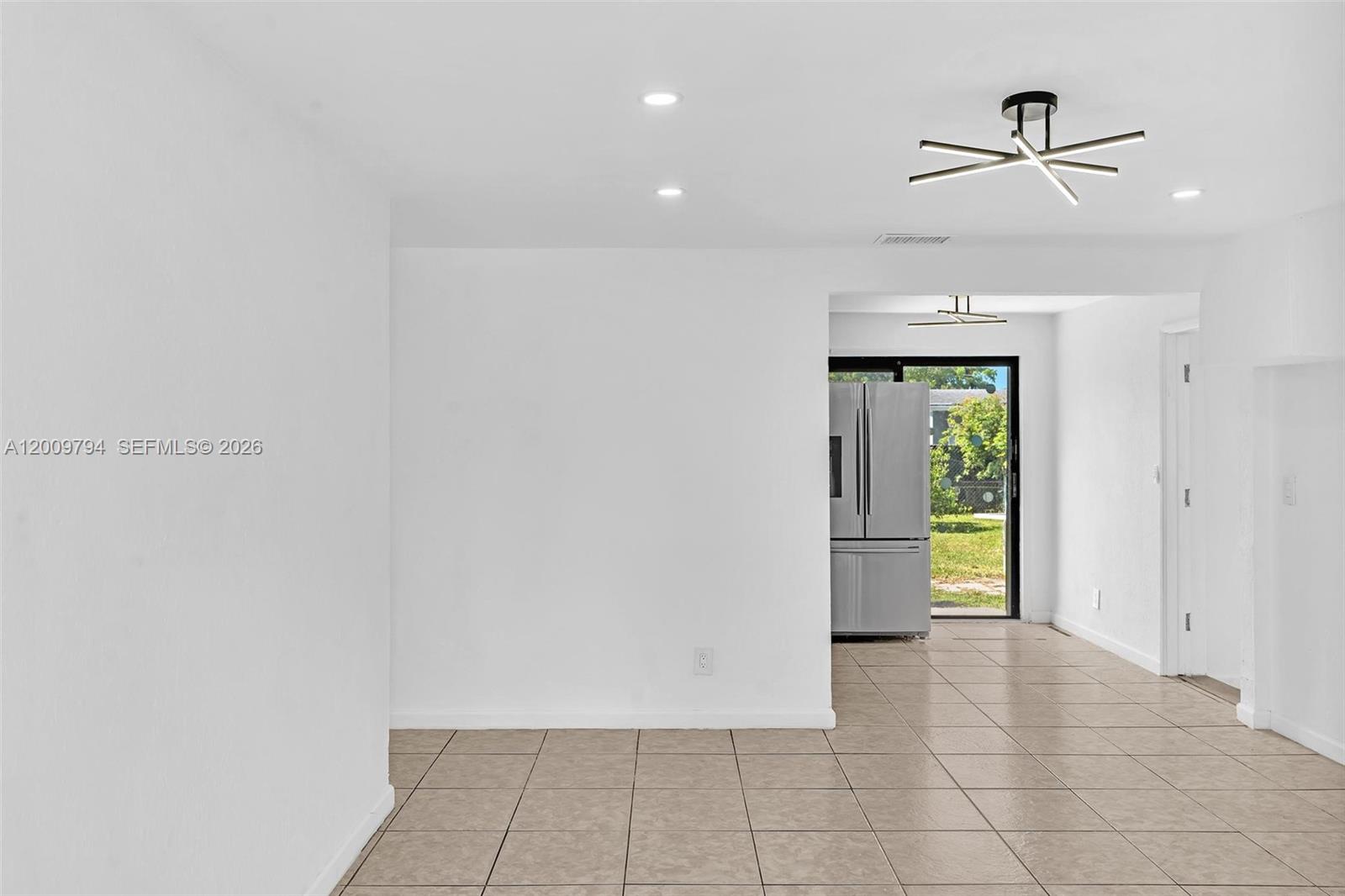 A room with white walls, tile flooring, a modern ceiling light, and a sliding door — 4156 SW 49th Ct # 0, Dania Beach FL 33314, DANIA BEACH, FL