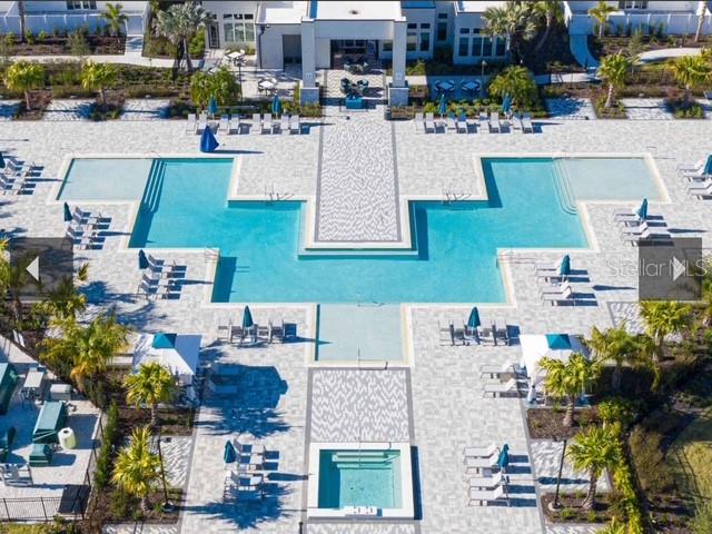 An aerial view shows a large swimming pool with a hot tub and lounge chairs — 1224 ROYAL VIEW TERRACE, KISSIMMEE, FL