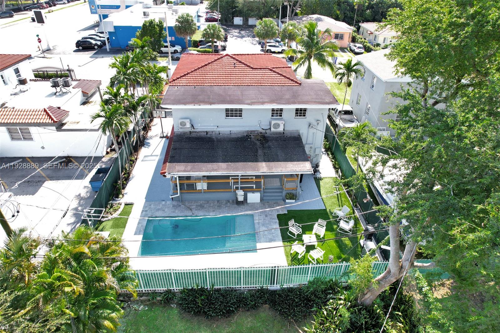 An aerial view shows a two-story house with a swimming pool and backyard patio — 3711 SW 27th Ter, Miami FL 33134, MIAMI, FL