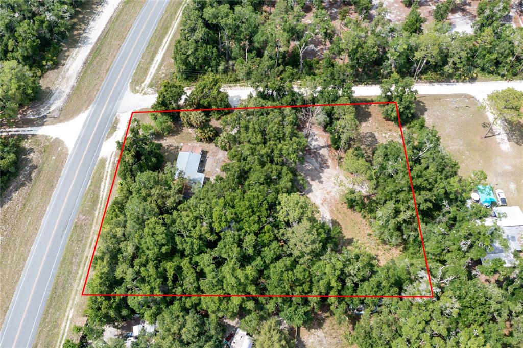 An aerial view shows a wooded lot with a house outlined in red — 9580 NE HIGHWAY 351, OLD TOWN, FL