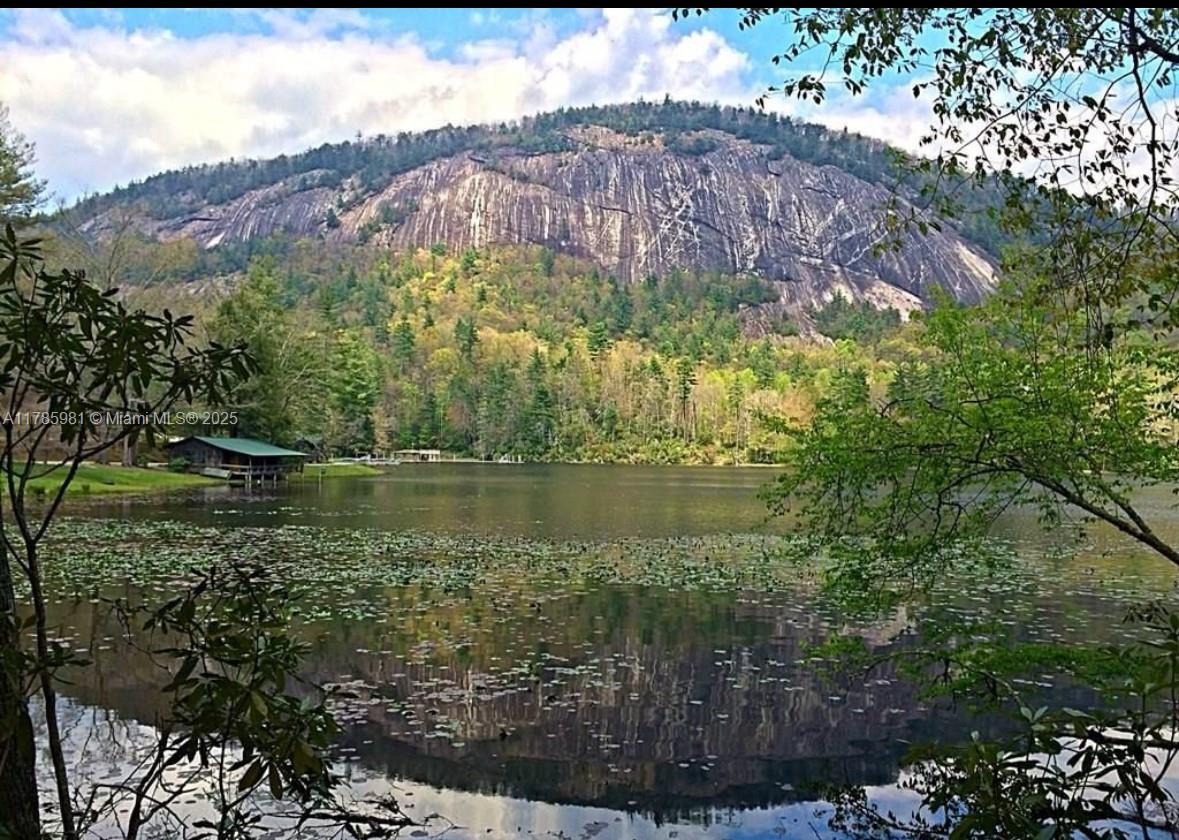 A lake sits in the foreground with a large, rocky mountain rising in the background — Lot 66 Juniper Court, NC 28774, NC