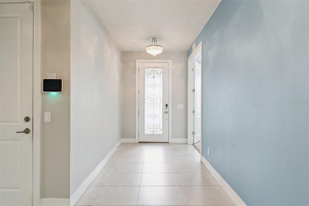A tiled entryway features a front door with decorative glass and a light blue wall — 2651 TAHOE TERRACE, ST CLOUD, FL