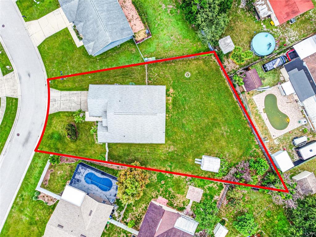This aerial view shows a residential property with a house, large yard, and surrounding homes — 232 KINGS POND AVENUE, WINTER HAVEN, FL