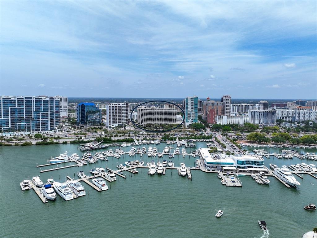 An aerial view of a marina with many boats docked in front of city buildings — 1255 N GULFSTREAM AVENUE UNIT 507, SARASOTA, FL