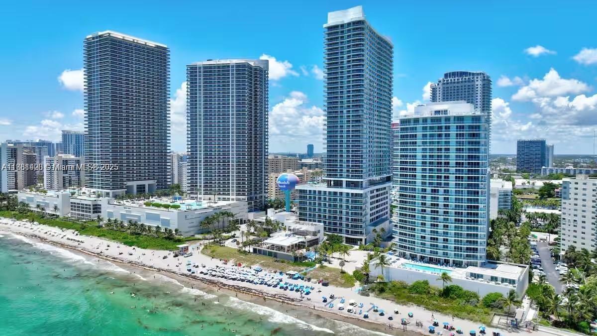 An aerial view of several high-rise residential buildings situated along a sandy beach and ocean — 4111 S Ocean Dr # 1801, Hollywood FL 33019, HOLLYWOOD, FL