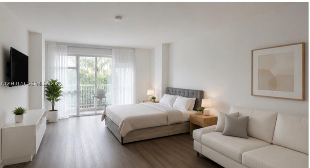 A bedroom with a bed, sofa, television, and sliding glass doors leading to a balcony — 10275 Collins Ave # 115, Bal Harbour FL 33154, BAL HARBOUR, FL